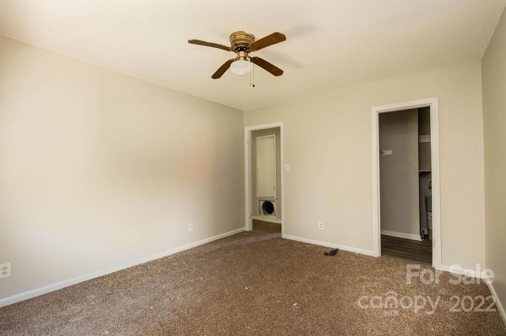 1219 County Home Road Conover, NC 28613 - Photo 25 of 48 an empty room with ceiling fan and window