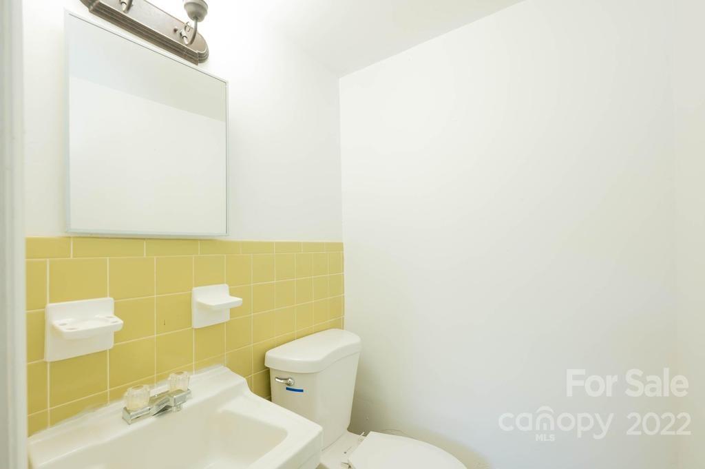 1219 County Home Road Conover, NC 28613 - Photo 27 of 48 a bathroom with a sink a toilet and mirror