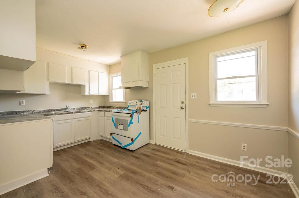 1219 County Home Road Conover, NC 28613 - Photo 36 of 48 a kitchen with cabinets wooden floor and a sink