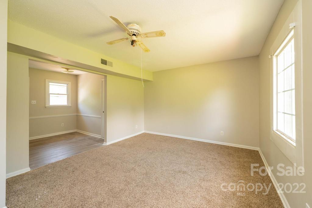1219 County Home Road Conover, NC 28613 - Photo 39 of 48 wooden floor in an empty room with a window