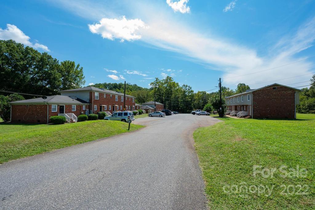1219 County Home Road Conover, NC 28613 - Photo 4 of 48 a view of a garden with a building in the background