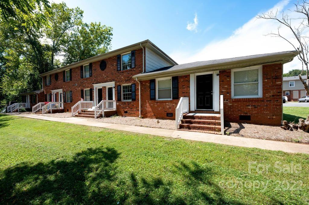 1219 County Home Road Conover, NC 28613 - Photo 9 of 48 a house view with swimming pool and wooden bench
