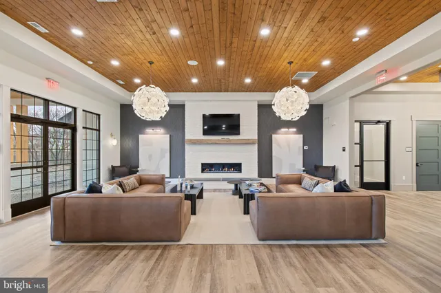 a living room with fireplace furniture and a flat screen tv