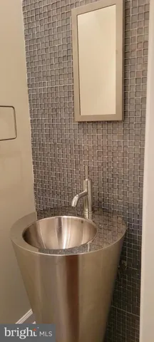 a bath tub sitting in a bathroom next to a sink