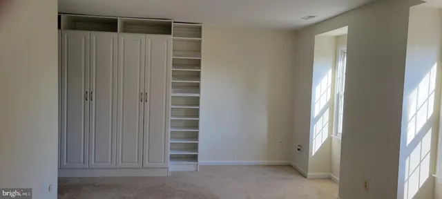 a view of wooden floor and windows in a room