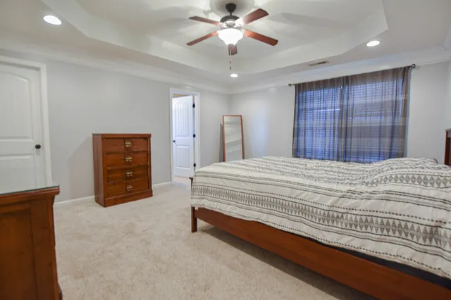 a bedroom with a bed and a ceiling fan