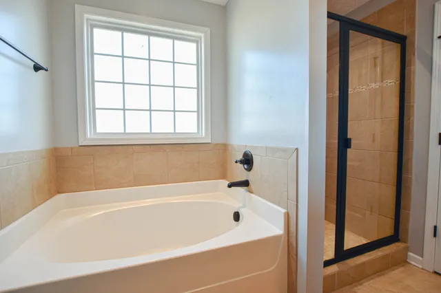 a white bath tub sitting next to a window
