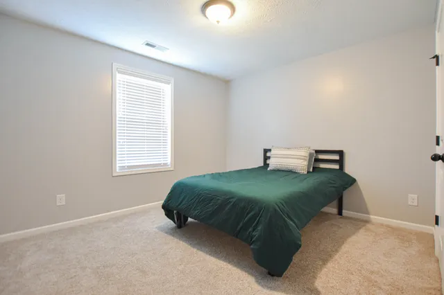 a bedroom with a bed and window