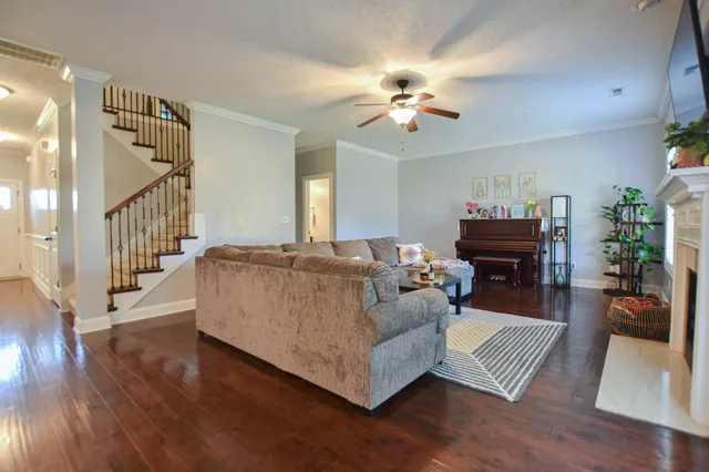a living room with furniture and wooden floor