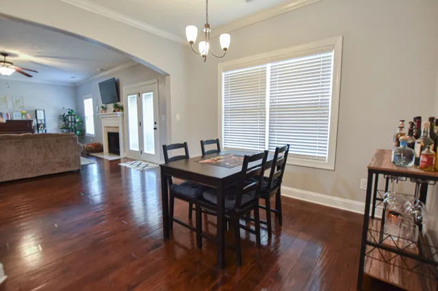 a view of a dining room with furniture wooden floor and chandelier