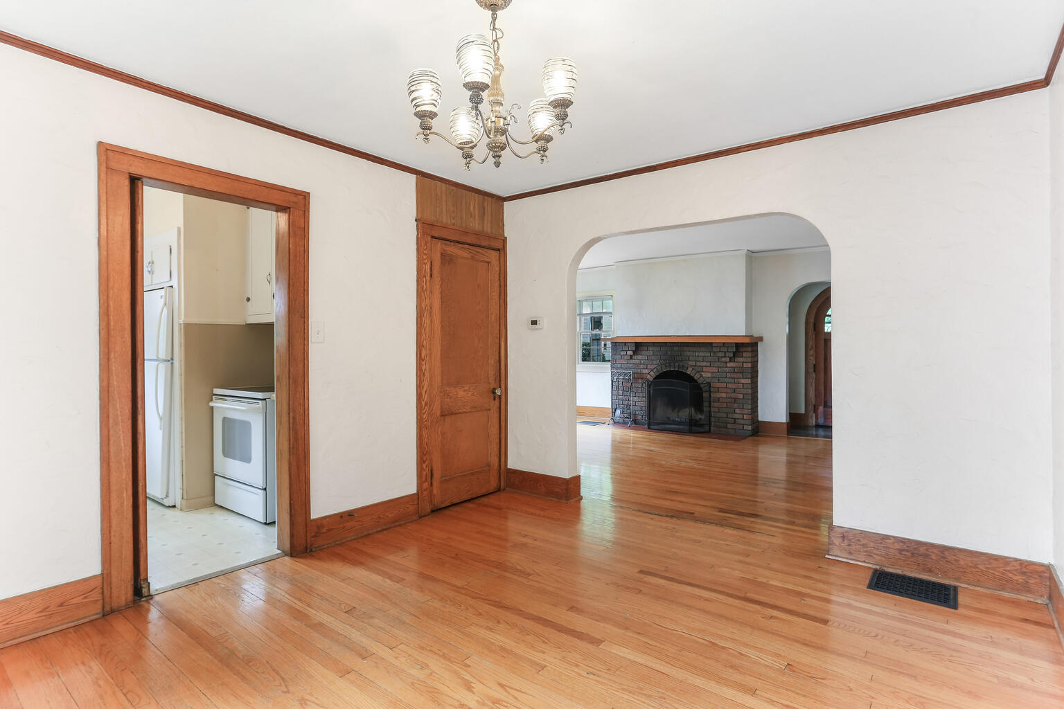 1206 West Healey Street Champaign, IL 61821 - Photo 11 of 42 a view of a livingroom with a fireplace wooden floor and a chandelier