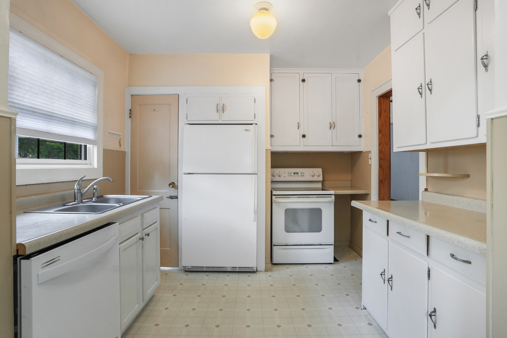 1206 West Healey Street Champaign, IL 61821 - Photo 12 of 42 a kitchen with white cabinets and white appliances