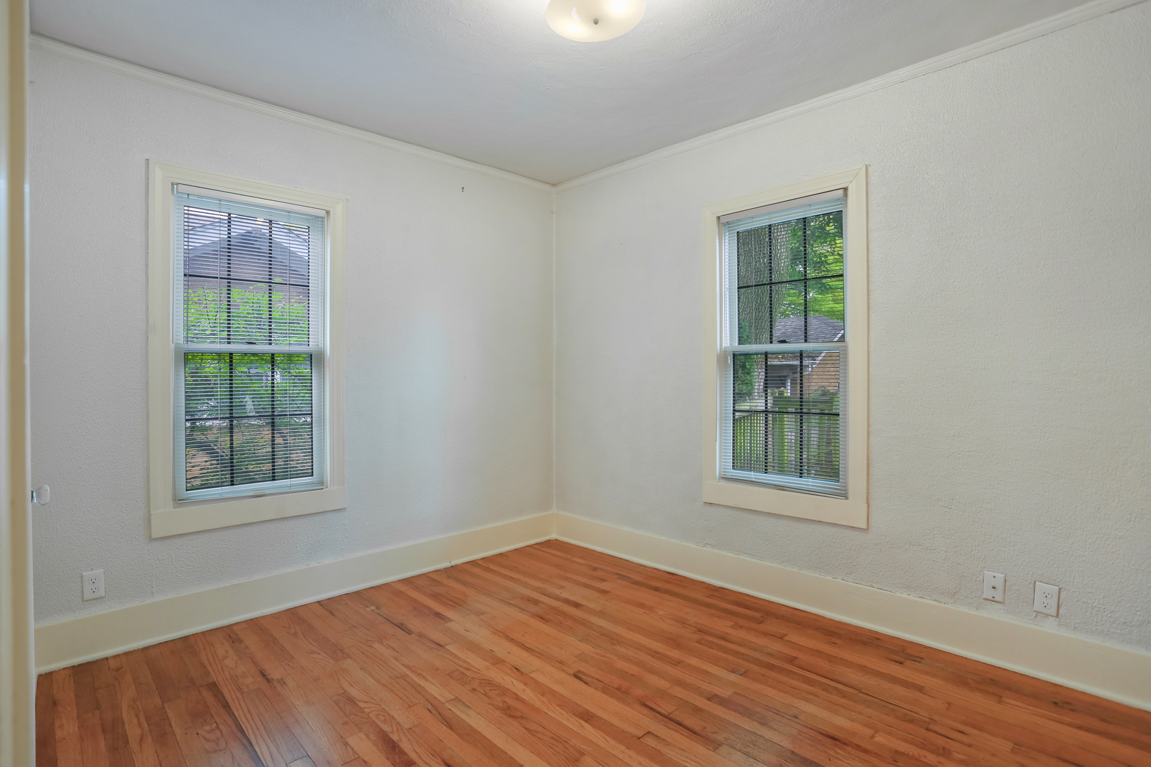 1206 West Healey Street Champaign, IL 61821 - Photo 20 of 42 an empty room with wooden floor and windows