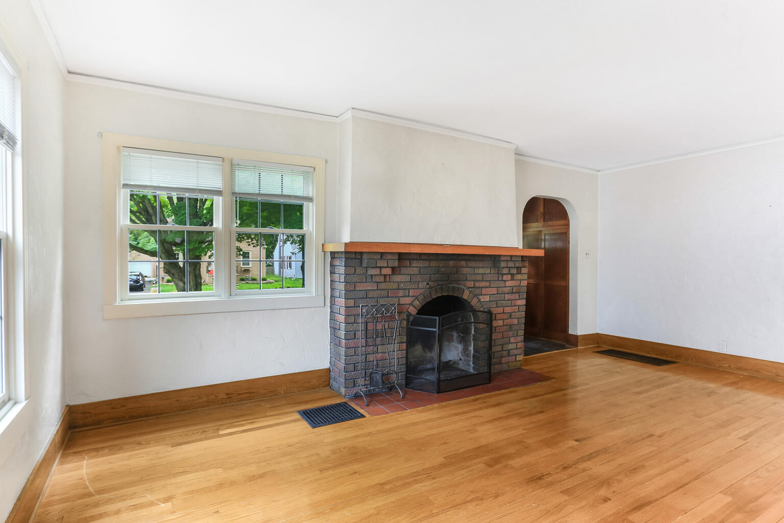 1206 West Healey Street Champaign, IL 61821 - Photo 6 of 42 a view of empty room with wooden floor and a fireplace