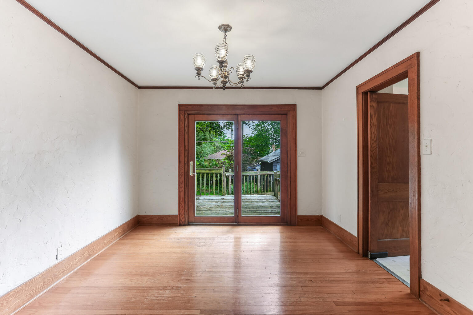 1206 West Healey Street Champaign, IL 61821 - Photo 10 of 42 a view of empty room with wooden floor and fan