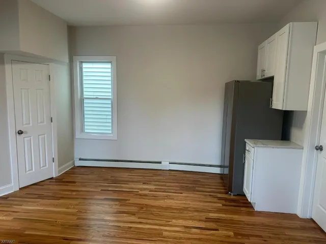 a view of room with window and wooden floor