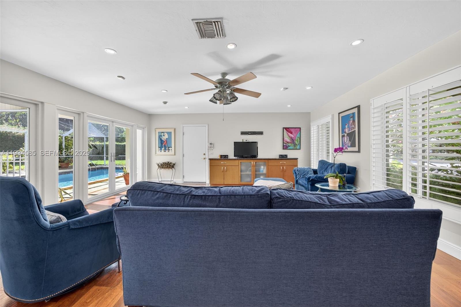 7300 Southwest 116th Terrace Pinecrest, FL 33156 - Photo 12 of 63 a living room with furniture and a large window