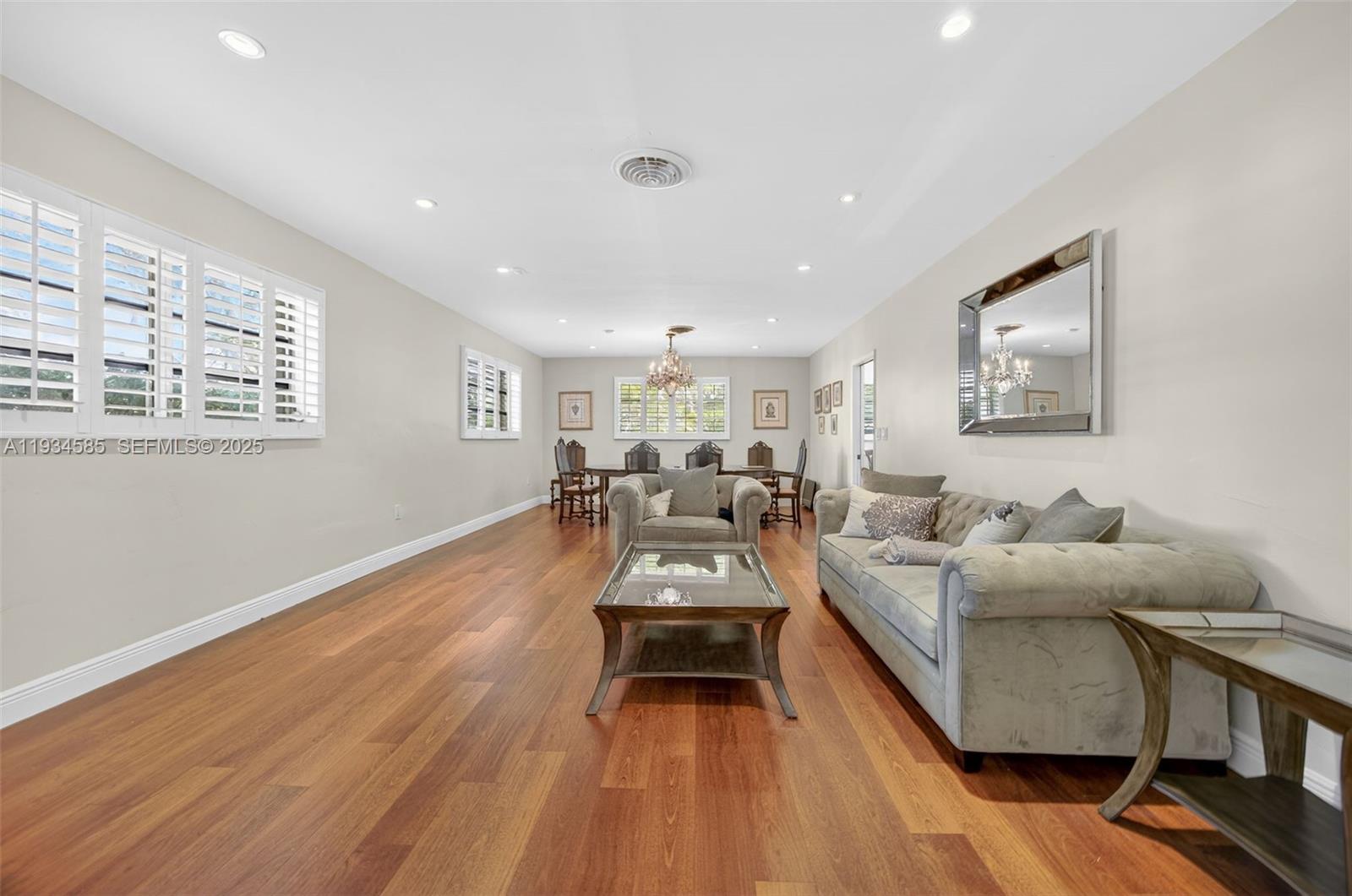 7300 Southwest 116th Terrace Pinecrest, FL 33156 - Photo 18 of 63 a living room with furniture and a wooden floor