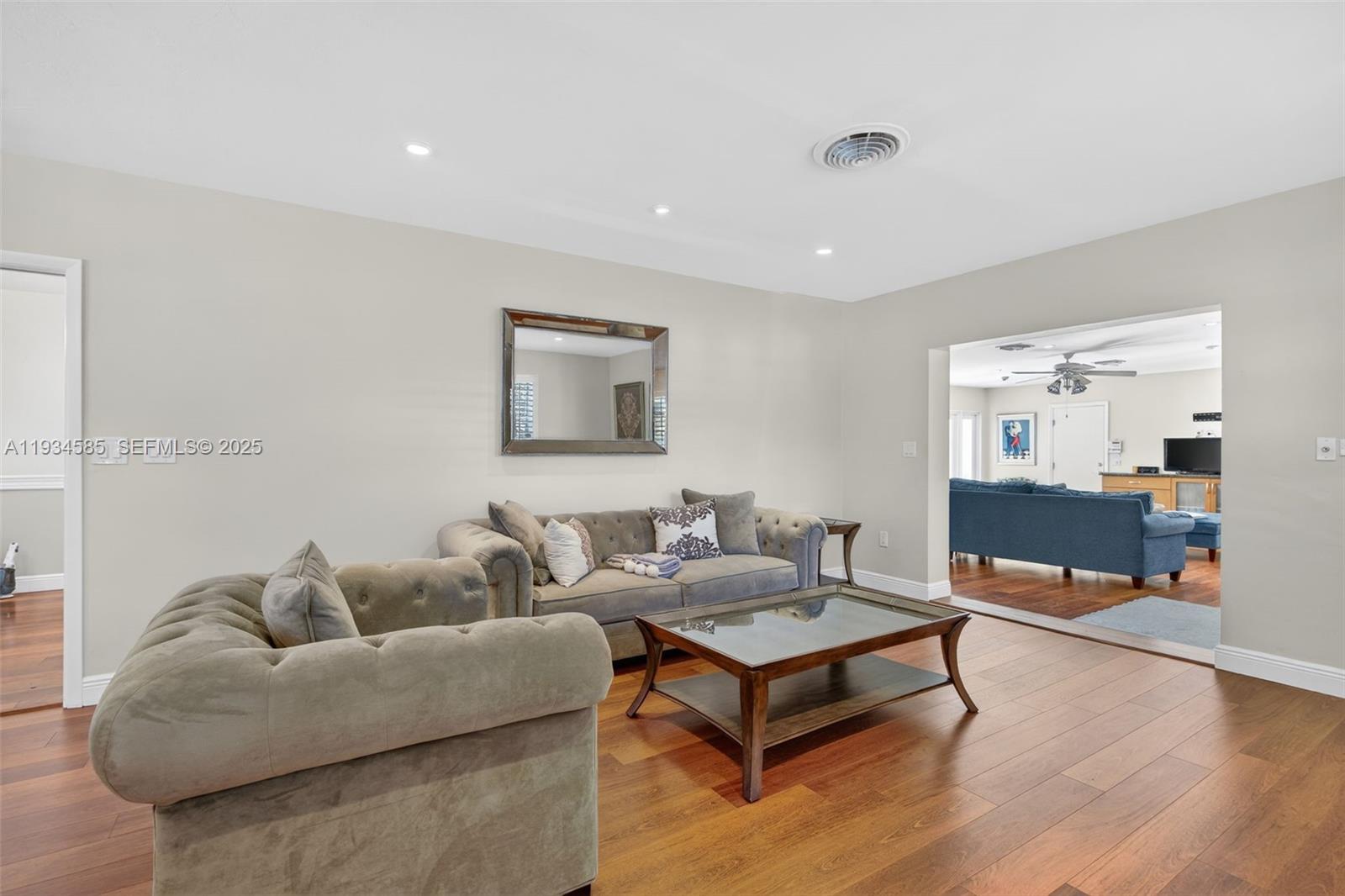 7300 Southwest 116th Terrace Pinecrest, FL 33156 - Photo 21 of 63 a living room with furniture and a wooden floor