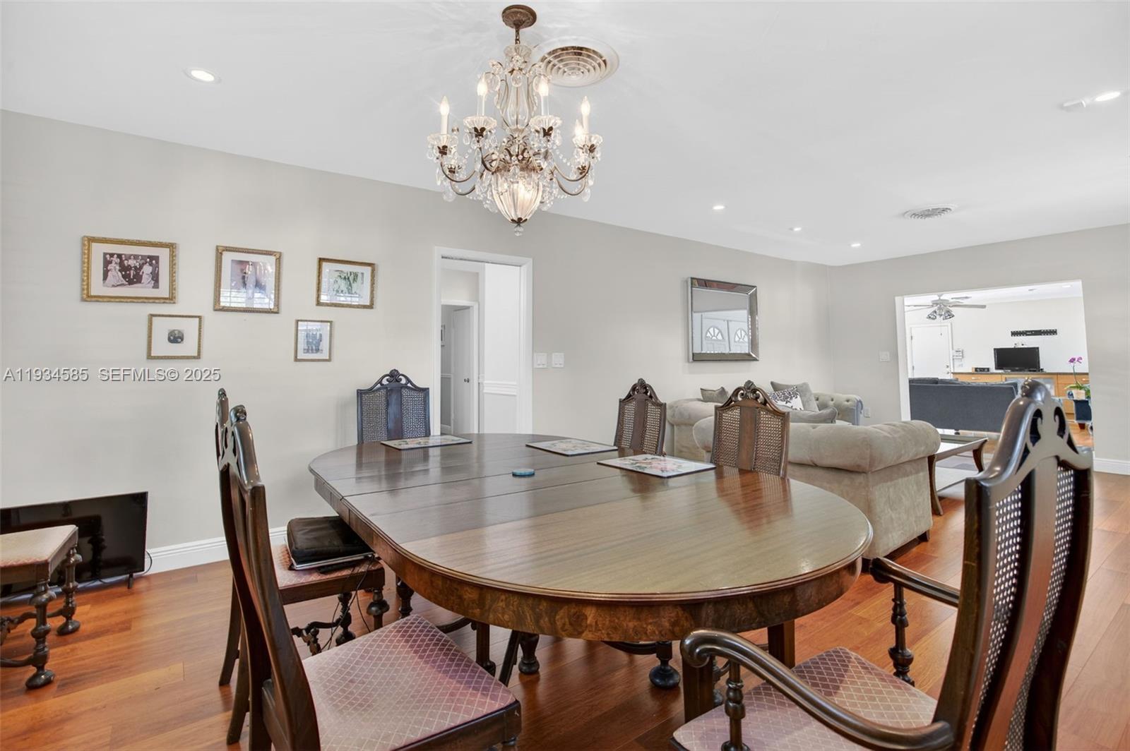 7300 Southwest 116th Terrace Pinecrest, FL 33156 - Photo 24 of 63 a view of a dining room with furniture and wooden floor