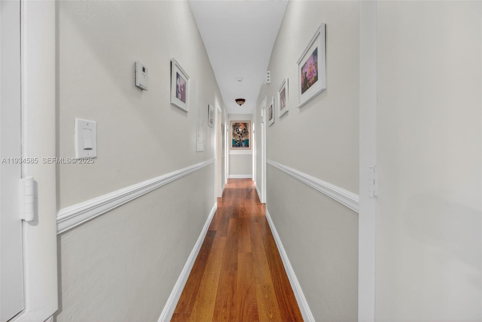 7300 Southwest 116th Terrace Pinecrest, FL 33156 - Photo 26 of 63 a view of a hallway with wooden floor and entryway