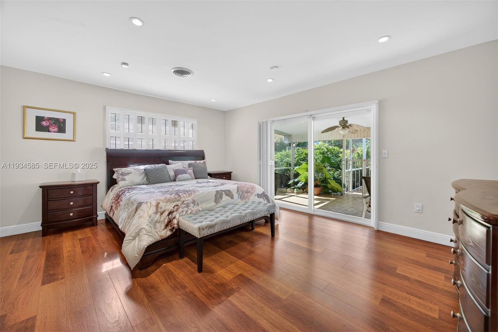 7300 Southwest 116th Terrace Pinecrest, FL 33156 - Photo 27 of 63 a bedroom with a bed and wooden floor