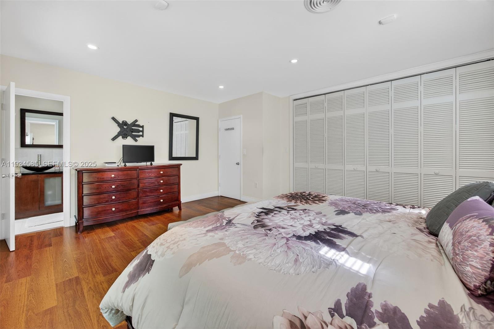 7300 Southwest 116th Terrace Pinecrest, FL 33156 - Photo 29 of 63 a bedroom with a bed and a dresser