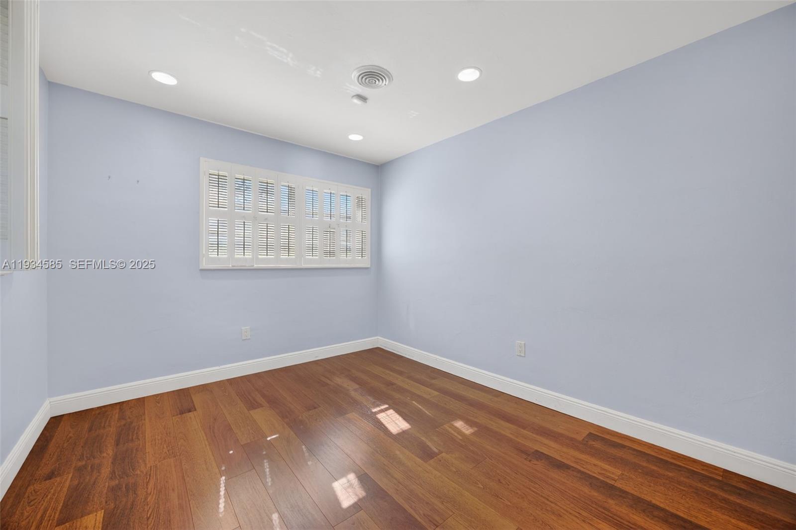 7300 Southwest 116th Terrace Pinecrest, FL 33156 - Photo 34 of 63 wooden floor in an empty room with a window