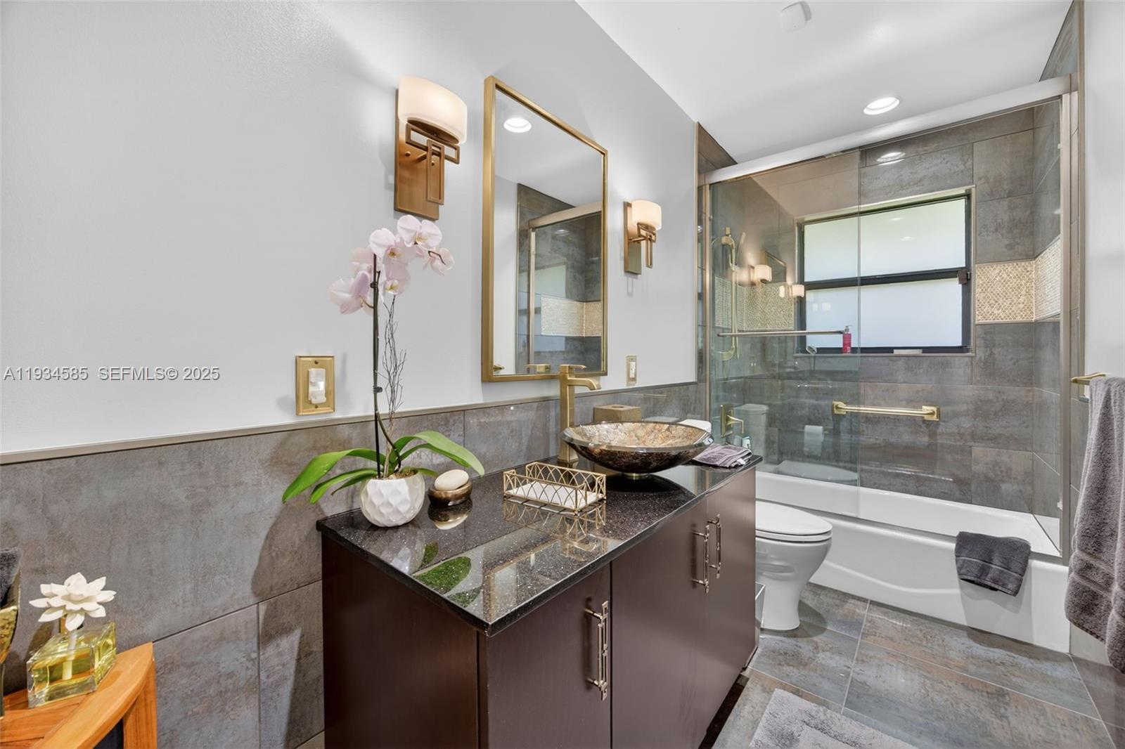 7300 Southwest 116th Terrace Pinecrest, FL 33156 - Photo 37 of 63 a bathroom with a granite countertop sink a toilet and mirror