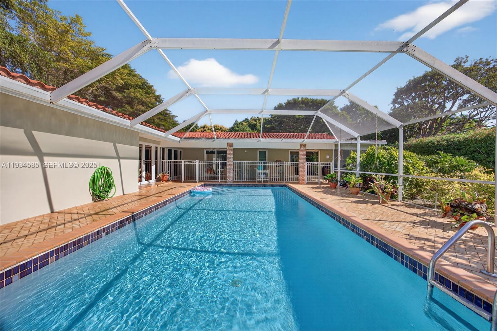 7300 Southwest 116th Terrace Pinecrest, FL 33156 - Photo 54 of 63 a view of a house with a swimming pool