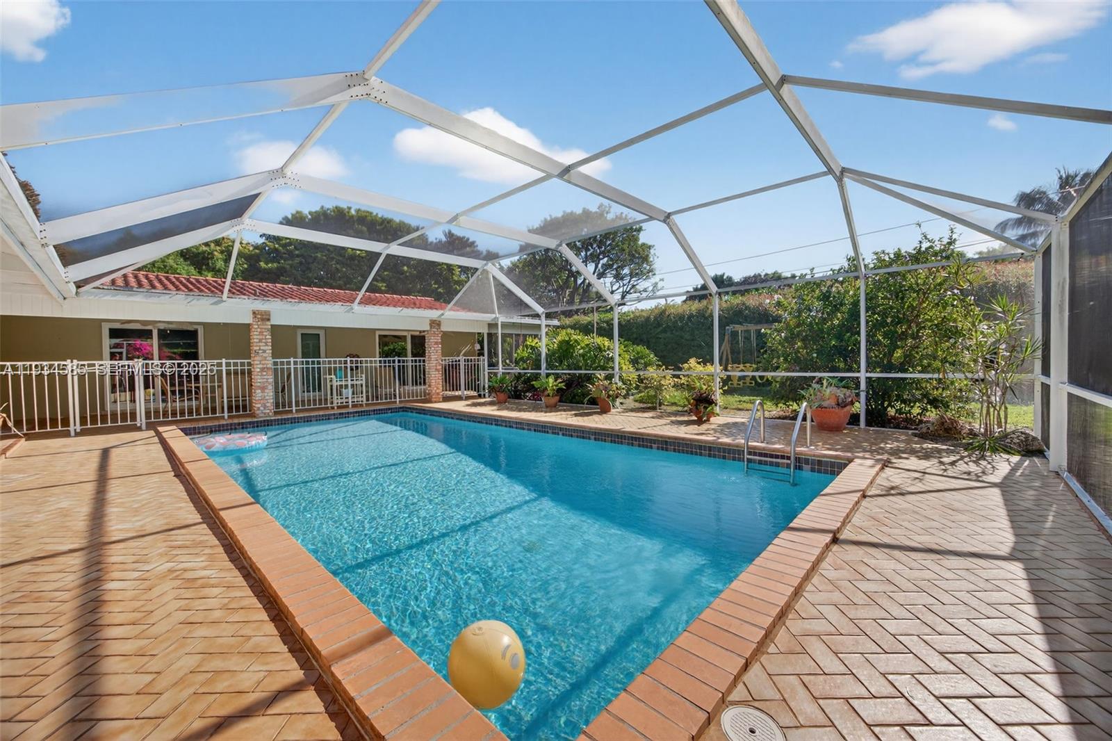 7300 Southwest 116th Terrace Pinecrest, FL 33156 - Photo 55 of 63 a view of a swimming pool with a patio