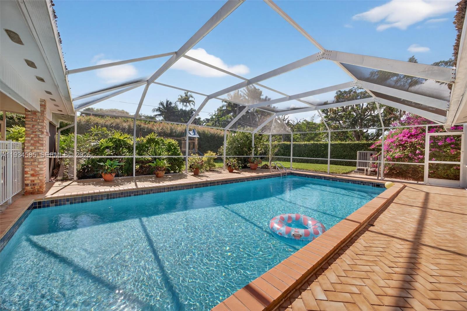 7300 Southwest 116th Terrace Pinecrest, FL 33156 - Photo 56 of 63 a view of a swimming pool with a patio