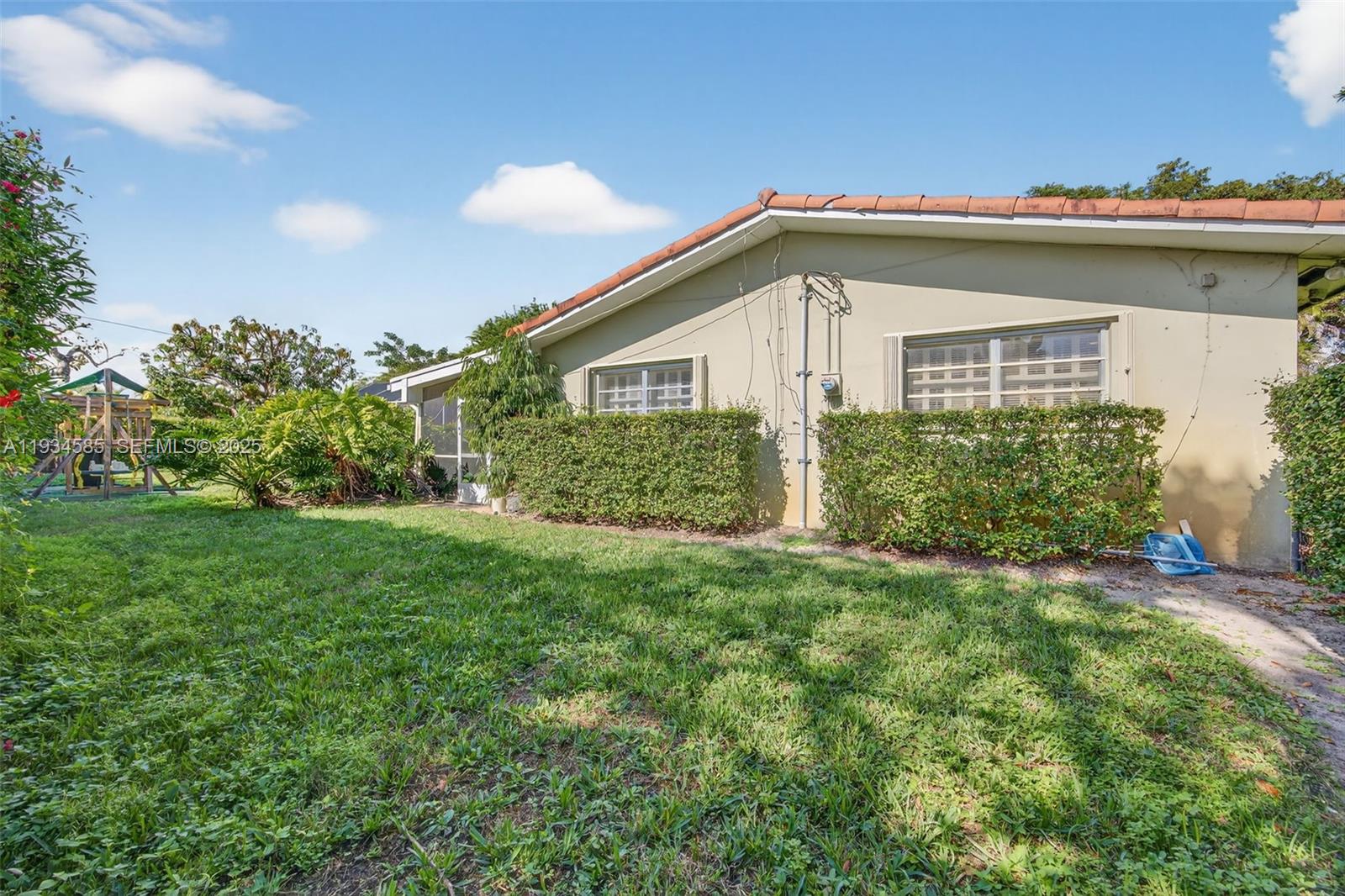 7300 Southwest 116th Terrace Pinecrest, FL 33156 - Photo 57 of 63 a view of a house with a big yard and potted plants