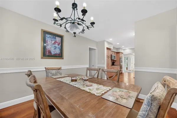 a large kitchen with cabinets wooden floor and stainless steel appliances