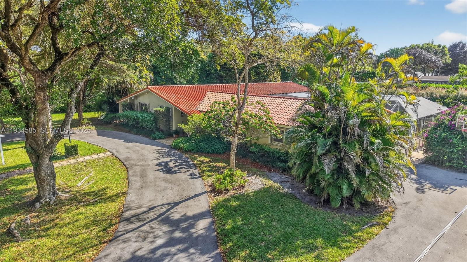 7300 Southwest 116th Terrace Pinecrest, FL 33156 - Photo 61 of 63 a view of a backyard with swimming pool