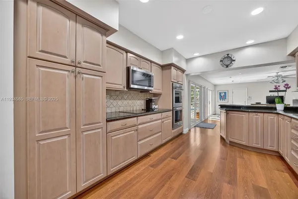 a kitchen with stainless steel appliances granite countertop a refrigerator and a sink