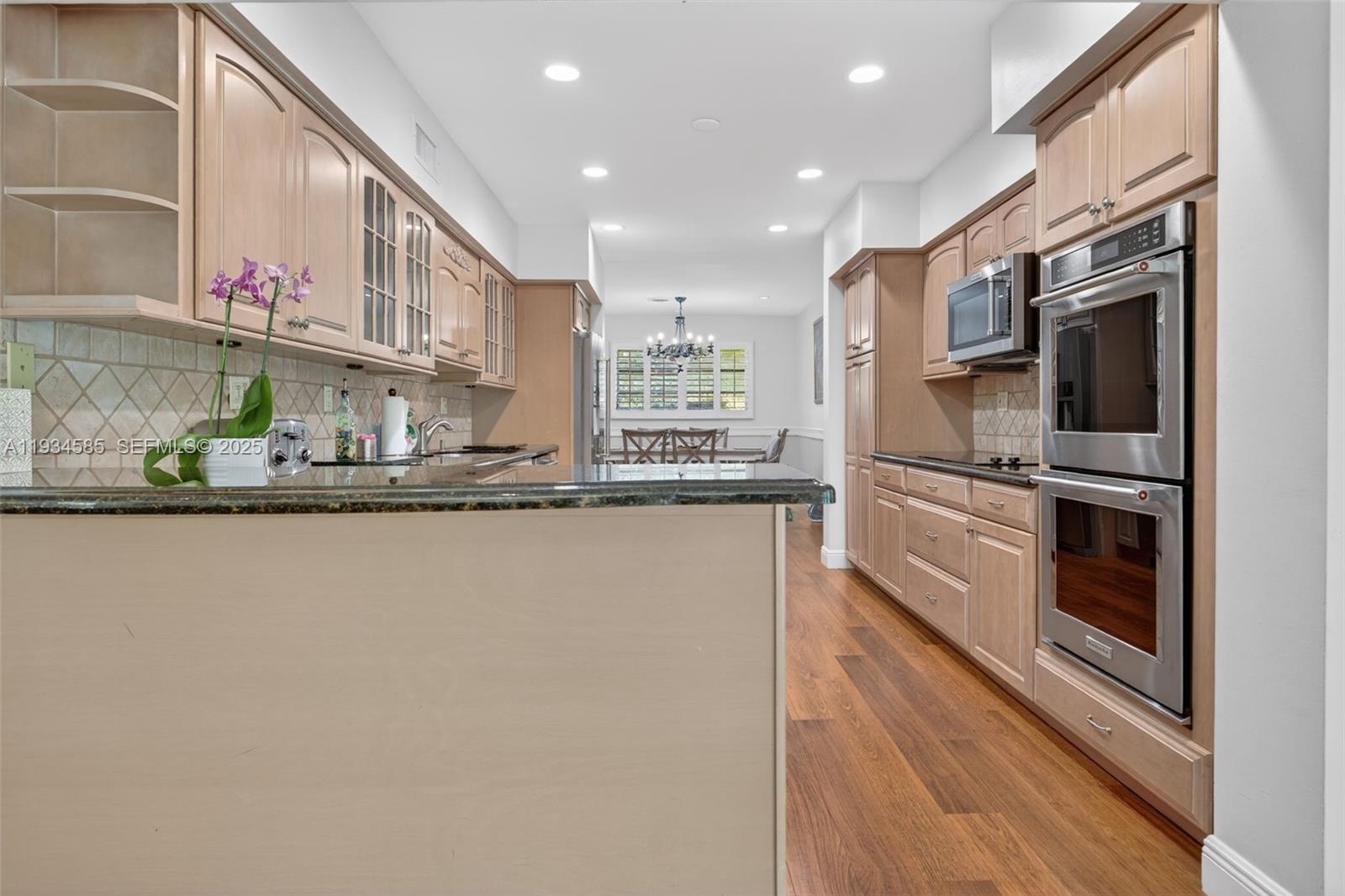 7300 Southwest 116th Terrace Pinecrest, FL 33156 - Photo 10 of 63 a kitchen with stainless steel appliances granite countertop a refrigerator and a sink