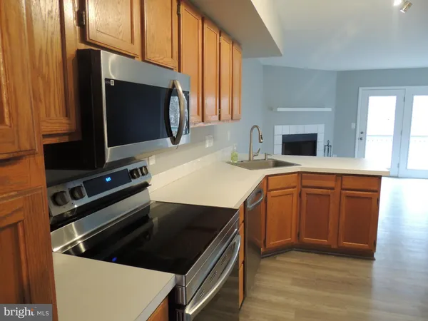 a view of a kitchen with wooden floor