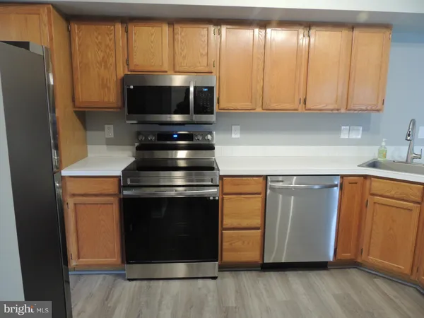 a kitchen with a stove a sink and a microwave