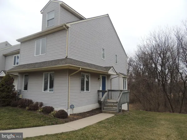 a view of a house with a yard and stairs