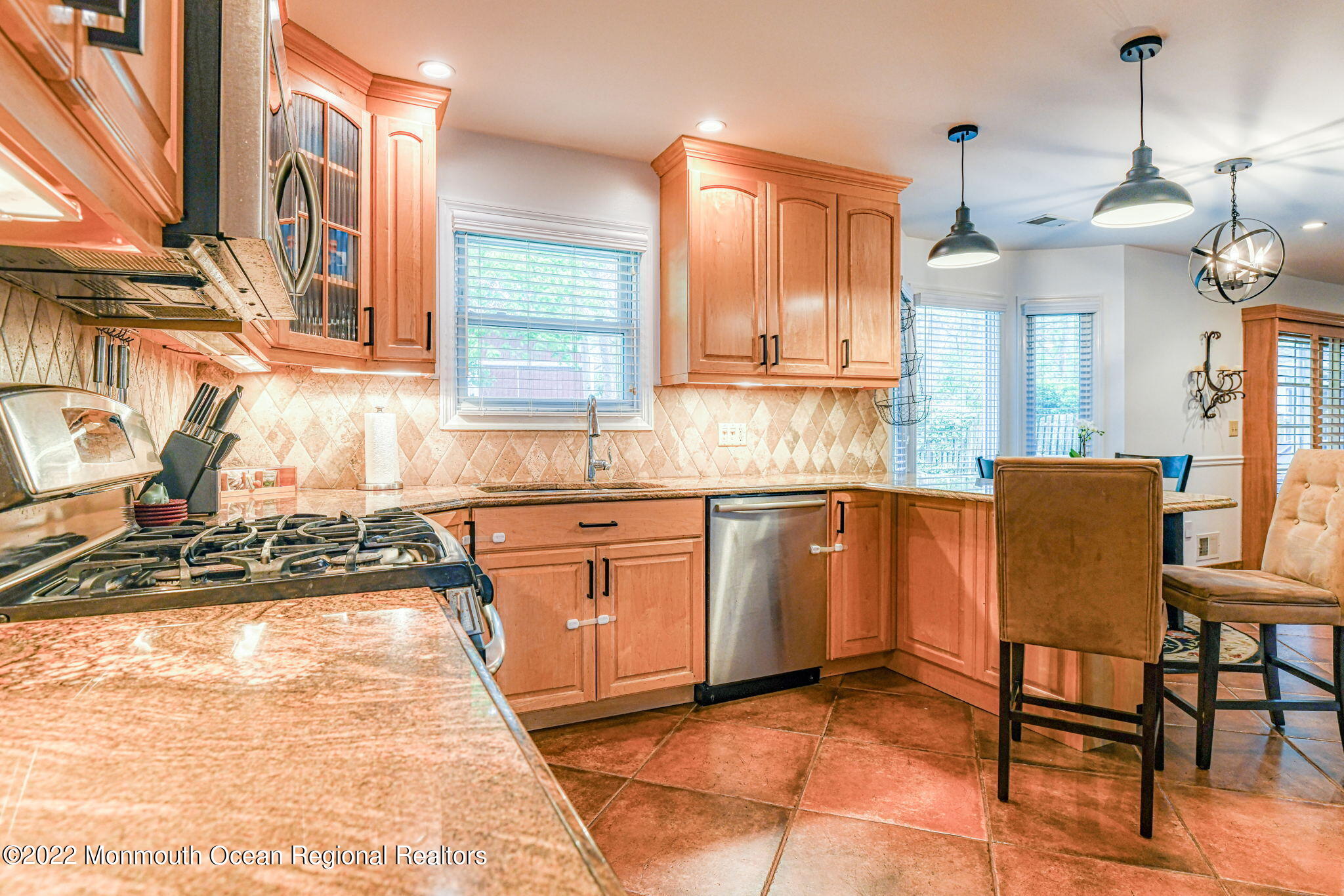 9 Sweet Gum Road Howell, NJ 07731 - Photo 12 of 38 a kitchen with stainless steel appliances granite countertop a sink and a wooden cabinets