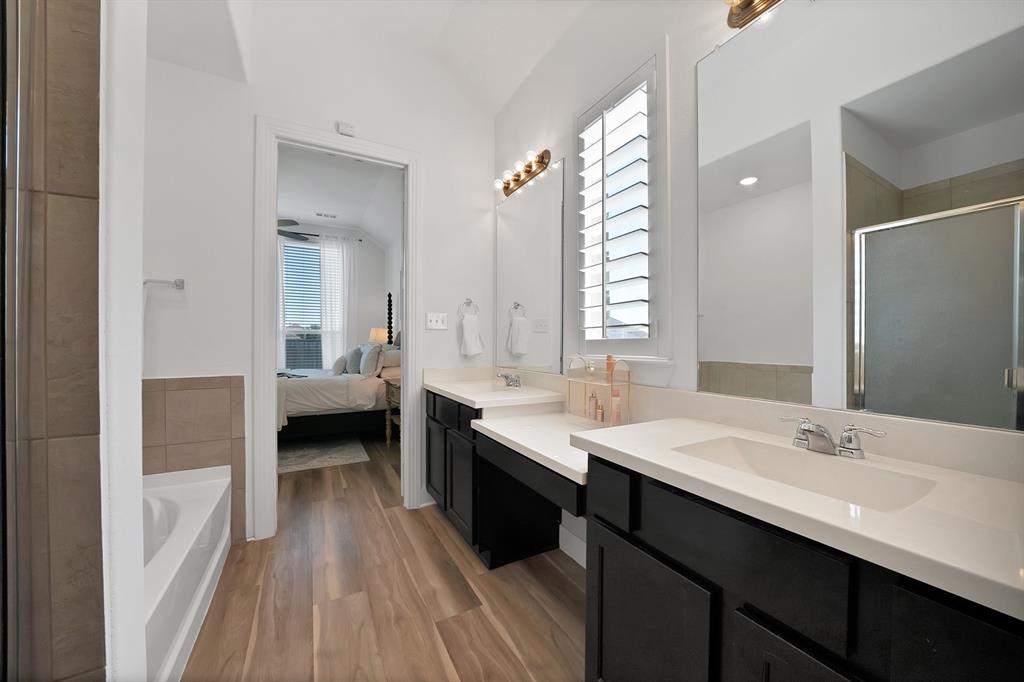 1709 Shetland Road Aubrey, TX 76227 - Photo 18 of 35 a en suite bathroom with a double vanity sink a mirror and a bathtub