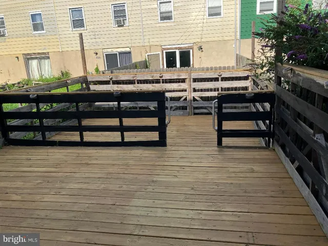 a bedroom with a bed and a mirror on the dresser
