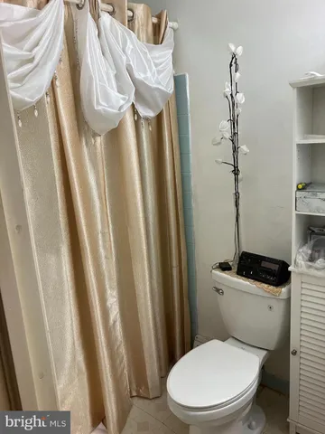 a bathroom with a sink toilet and mirror