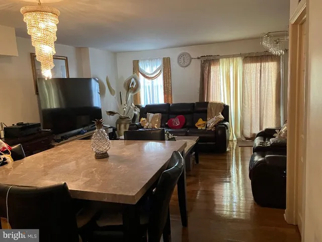 a dining room with furniture and wooden floor
