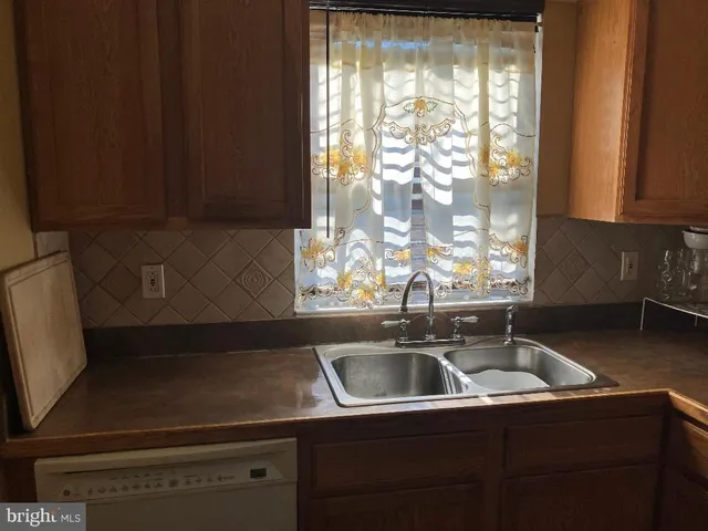 a kitchen with a sink and large window