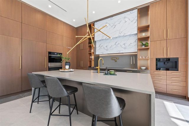 a work room with furniture and a large window