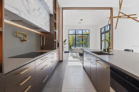a kitchen with stainless steel appliances a sink and a stove top oven