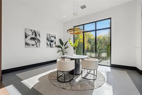 a hallway with wooden floor and furniture