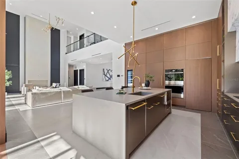 a kitchen with sink refrigerator and large window